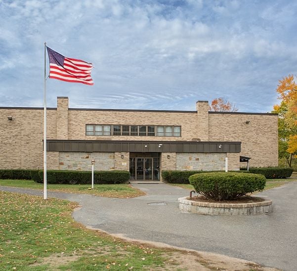 k12 school building with flags