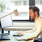 smiling-man-on-computer-white