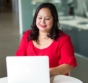 woman in red at laptop