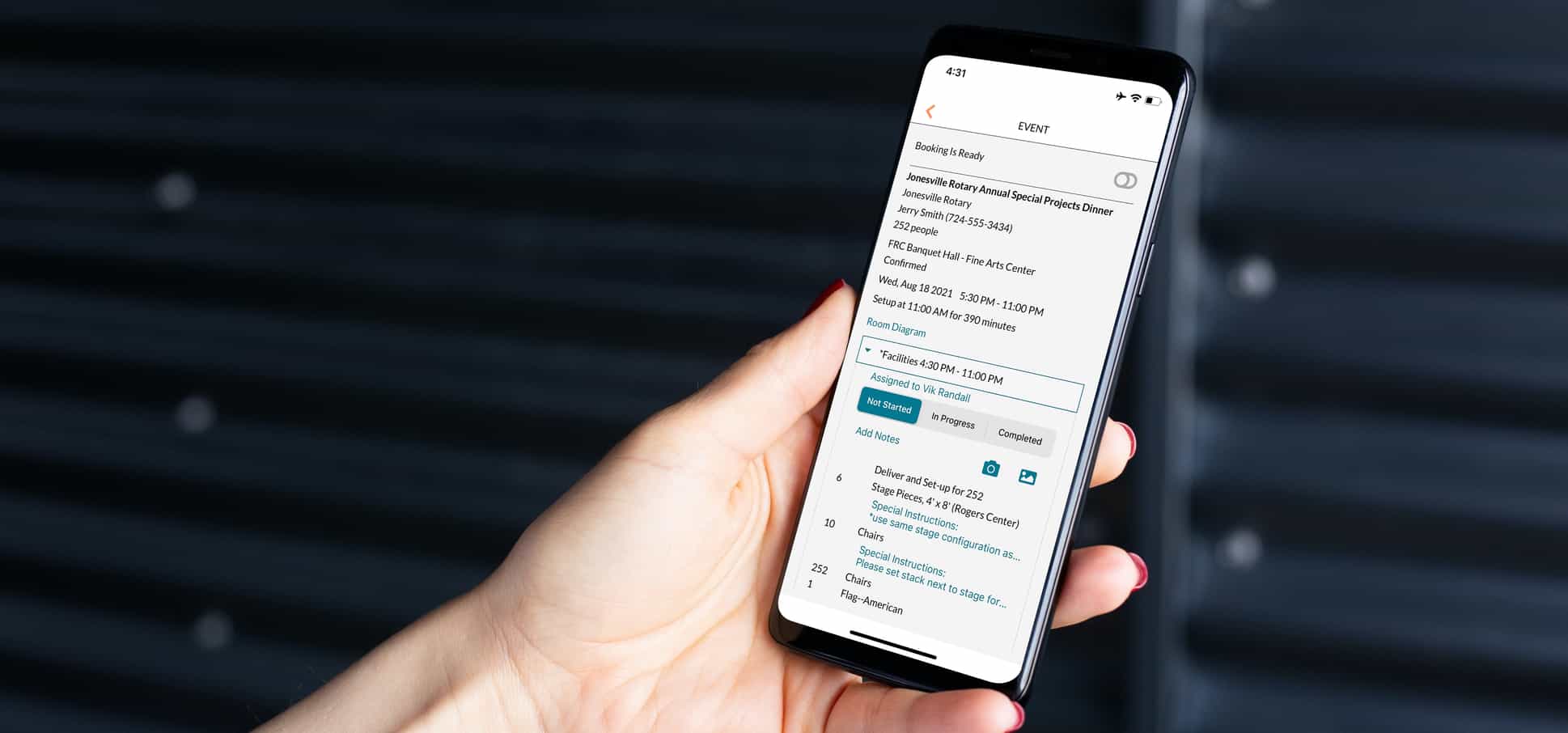 Hand holding phone with Mazévo ops app open. 