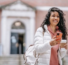 woman-white-coat-holding-phone