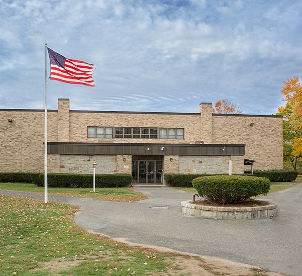 K12 school building with flag outside.