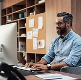 man working at computer smiling